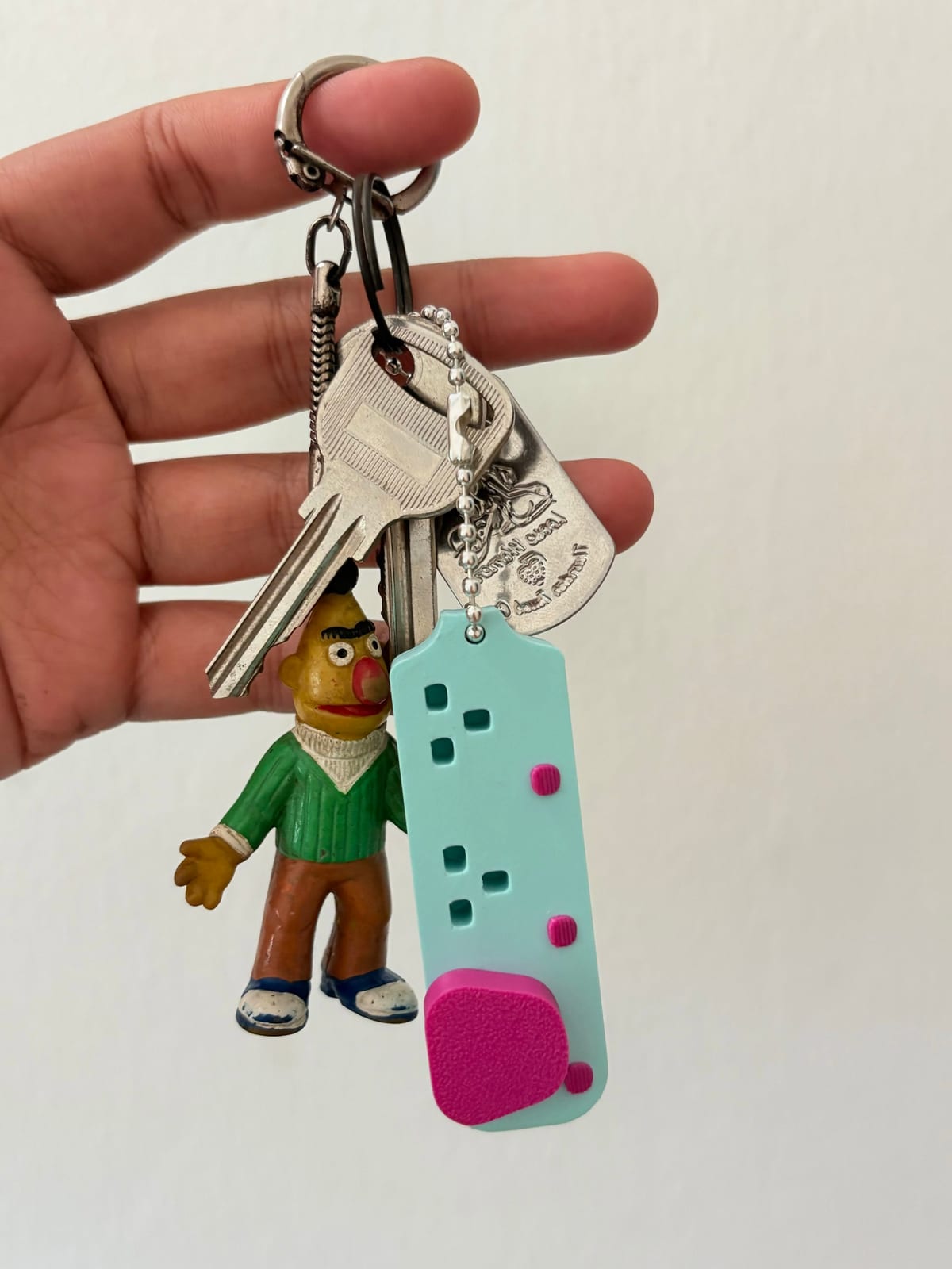 Mint extension plug keychain hanging from a set of house keys